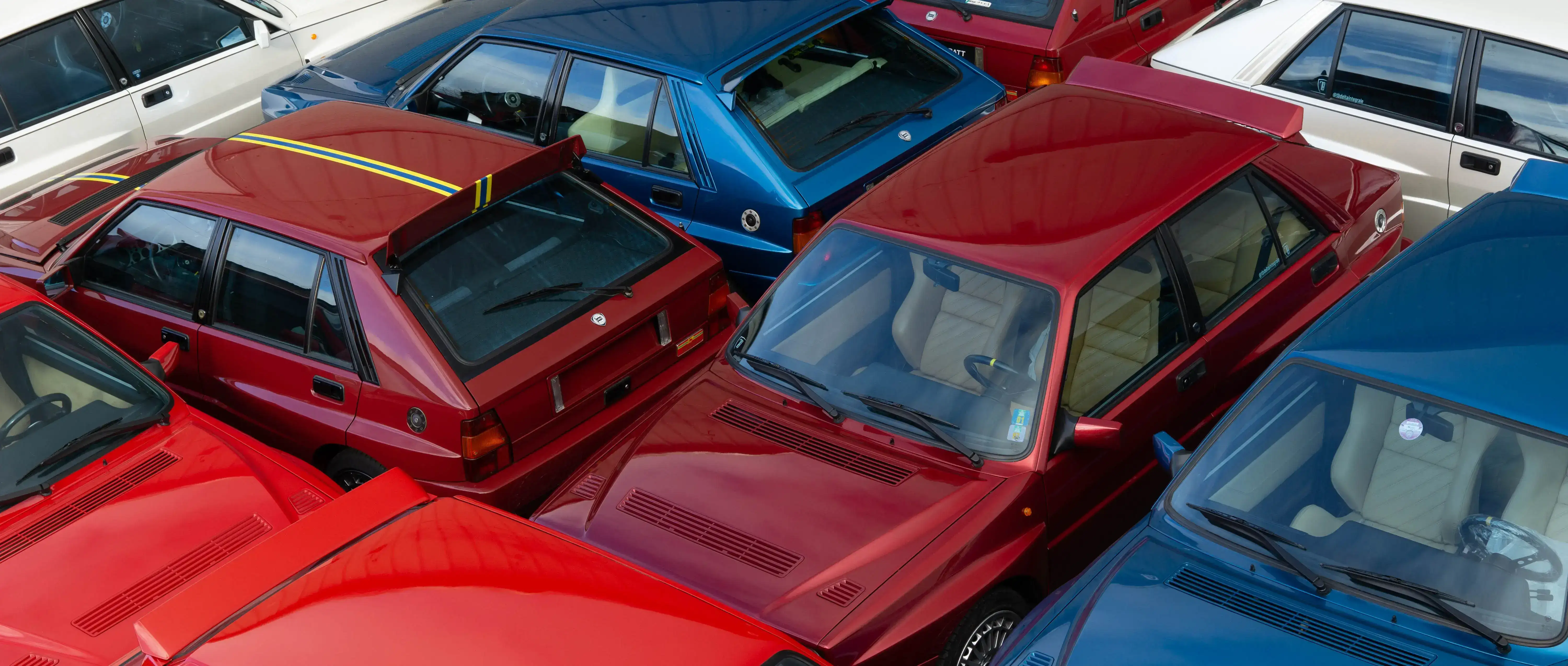 Colourful Lancia Deltas positioned in a pattern